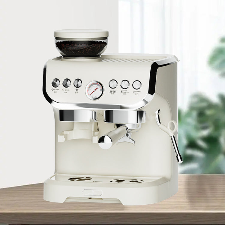 White espresso machine on a wooden surface with a blurred green plant in the background