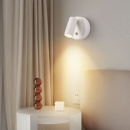 White wall lamp on its wireless charging base
