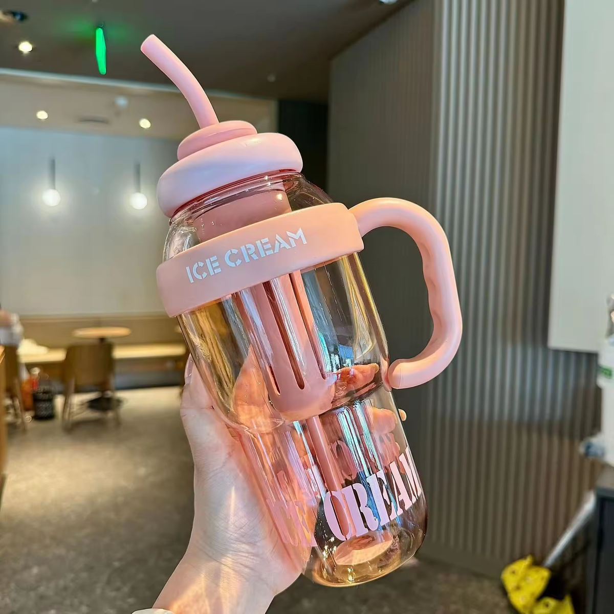 Reusable tumbler showing the fitted lid and drinking straw

