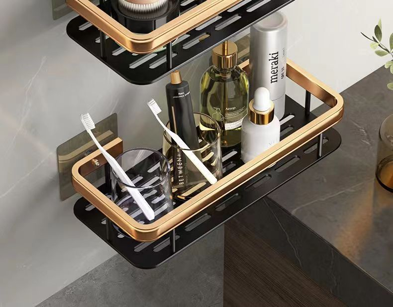 Wall-mounted aluminum shelf holding bathroom items
