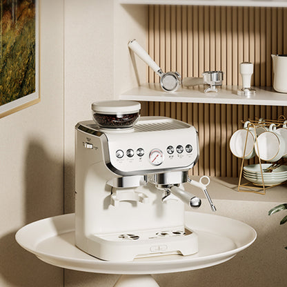 White espresso machine on a white plate with a kitchen setting in the background
