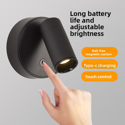 Black wall lamp detached from its magnetic base
